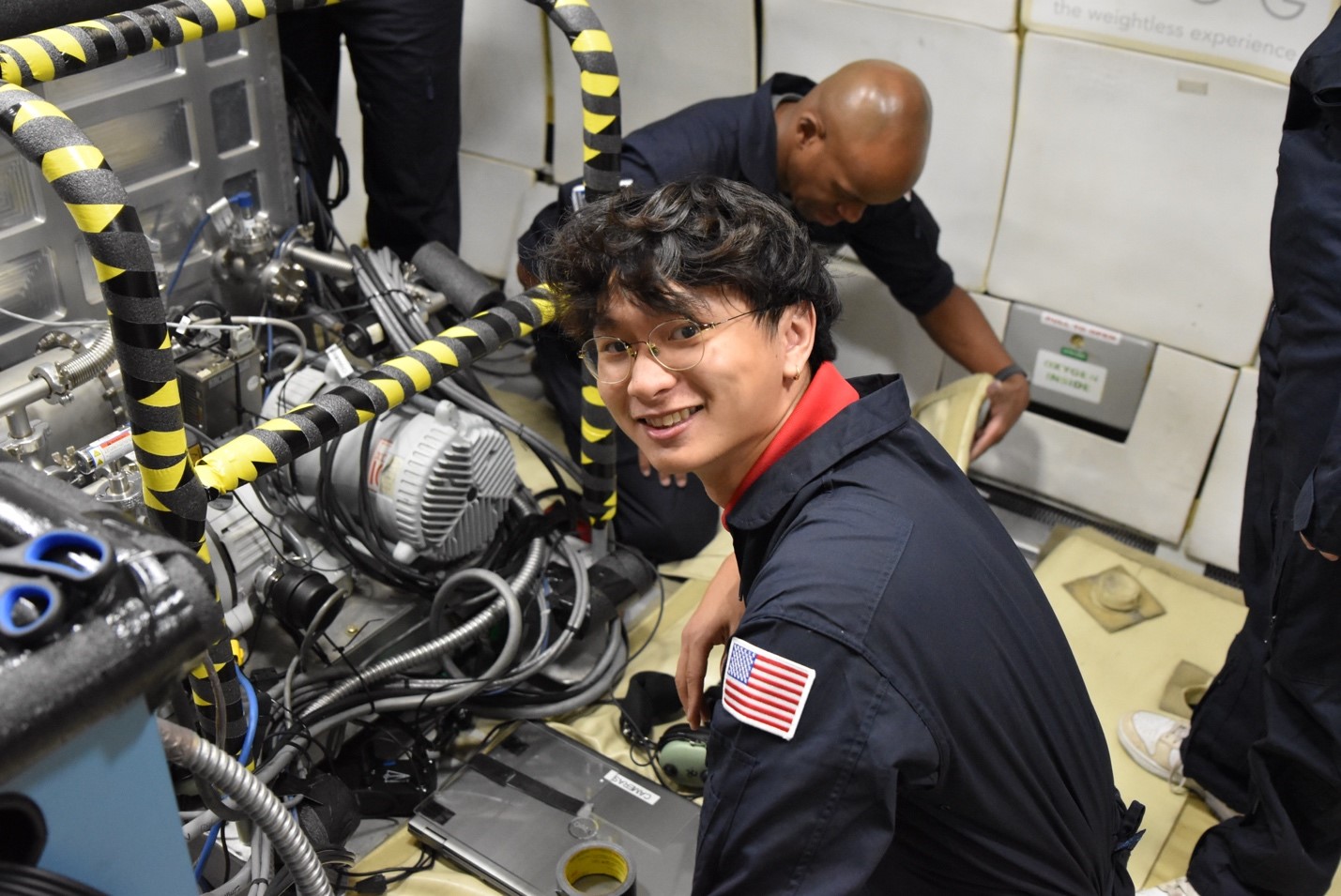 Ohio State student Eugene Choi sets up the vacuum chamber inside the Boeing 727