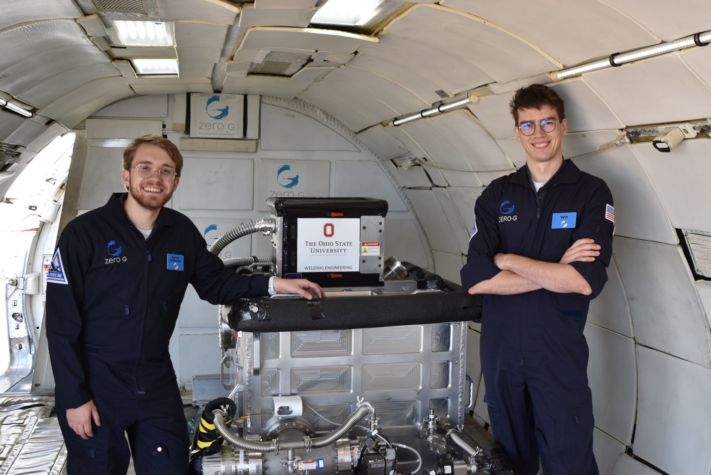 Ohio State students Aaron Brimmer (left) and Will McAuley (right) setting up the vacuum chamber inside the Zero G Boeing 727