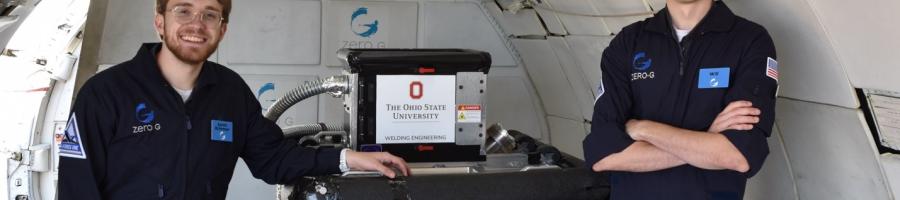 Ohio State students Aaron Brimmer (left) and Will McAuley (right) setting up the vacuum chamber inside the Zero G Boeing 727