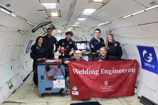 Ohio State team mix inside plane with flag