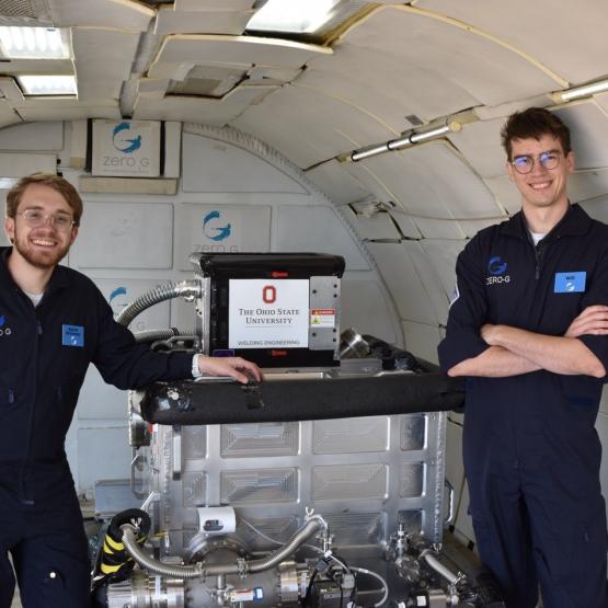 Ohio State students Aaron Brimmer (left) and Will McAuley (right) setting up the vacuum chamber inside the Zero G Boeing 727