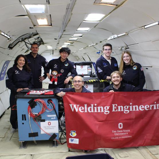 Ohio State team mix inside plane with flag